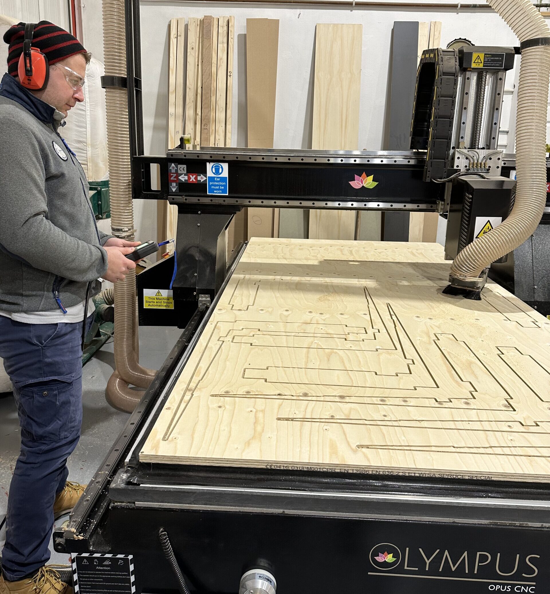 CNC machine cutting plywood seating parts