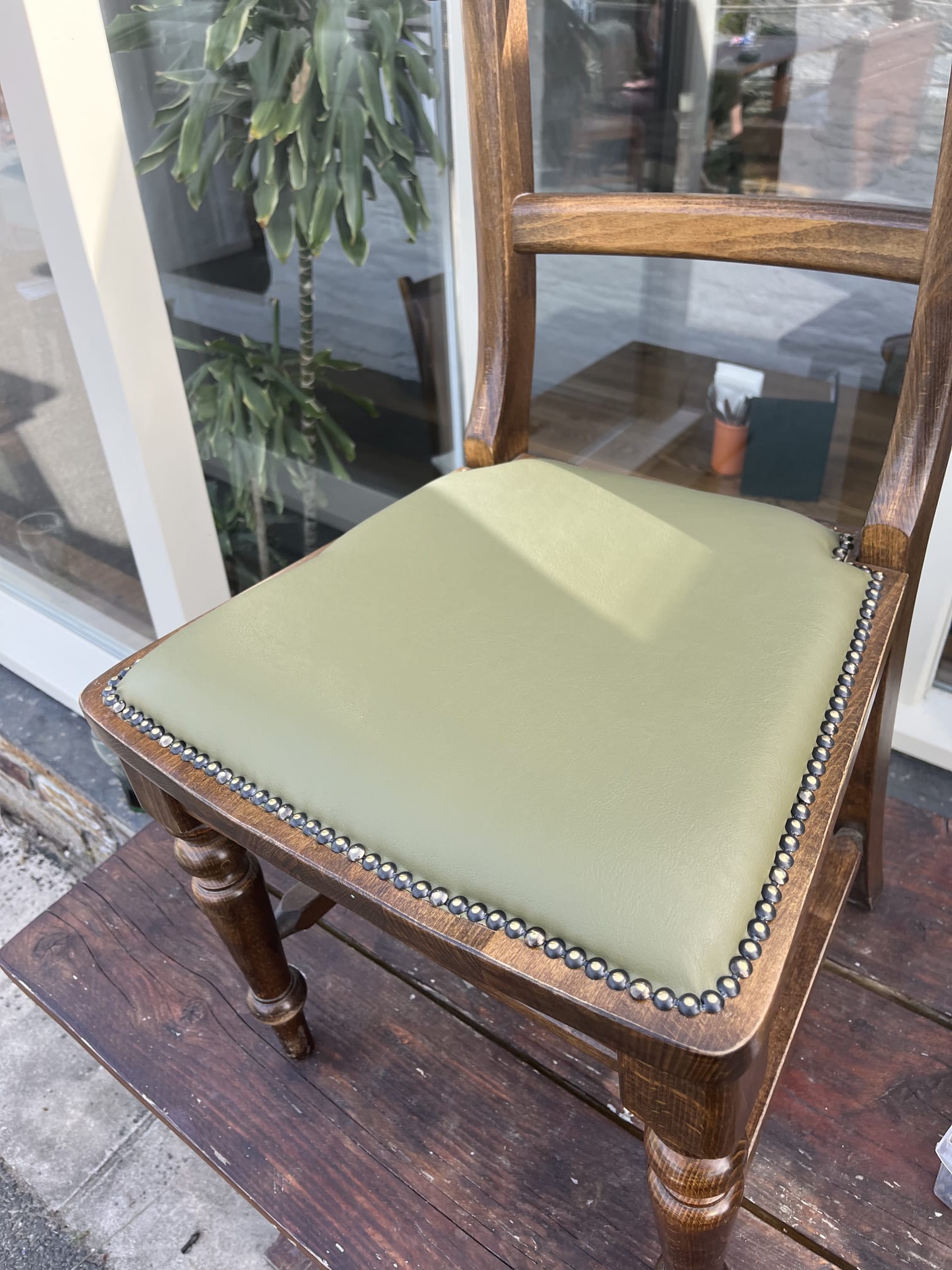 Victorian chair seats re-covered in sage green leather and finished with a hand-set antique stud border.