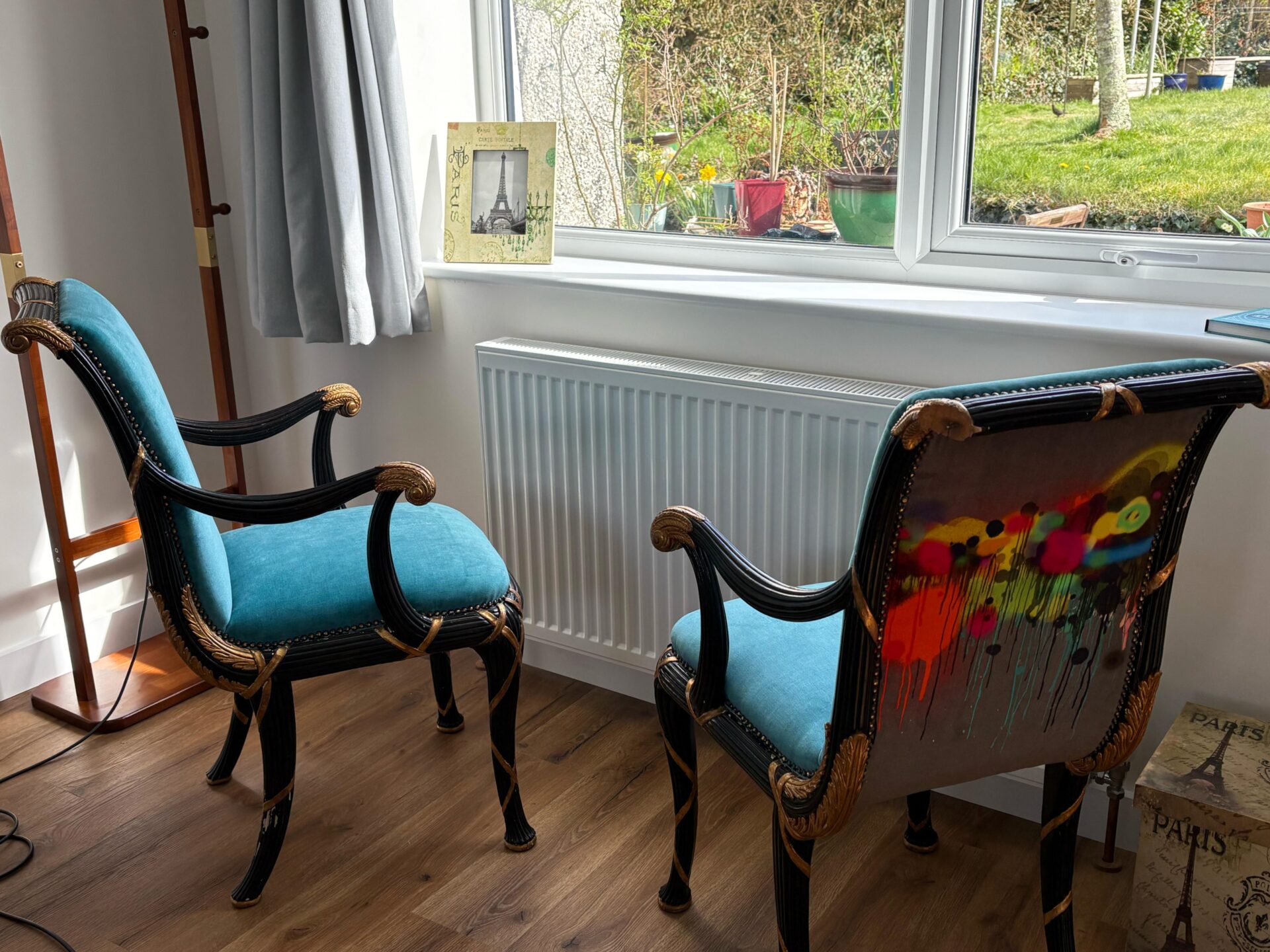 Pair of Regency-style armchairs reupholstered in teal velvet, with gilded frames and hand-painted outside backs.