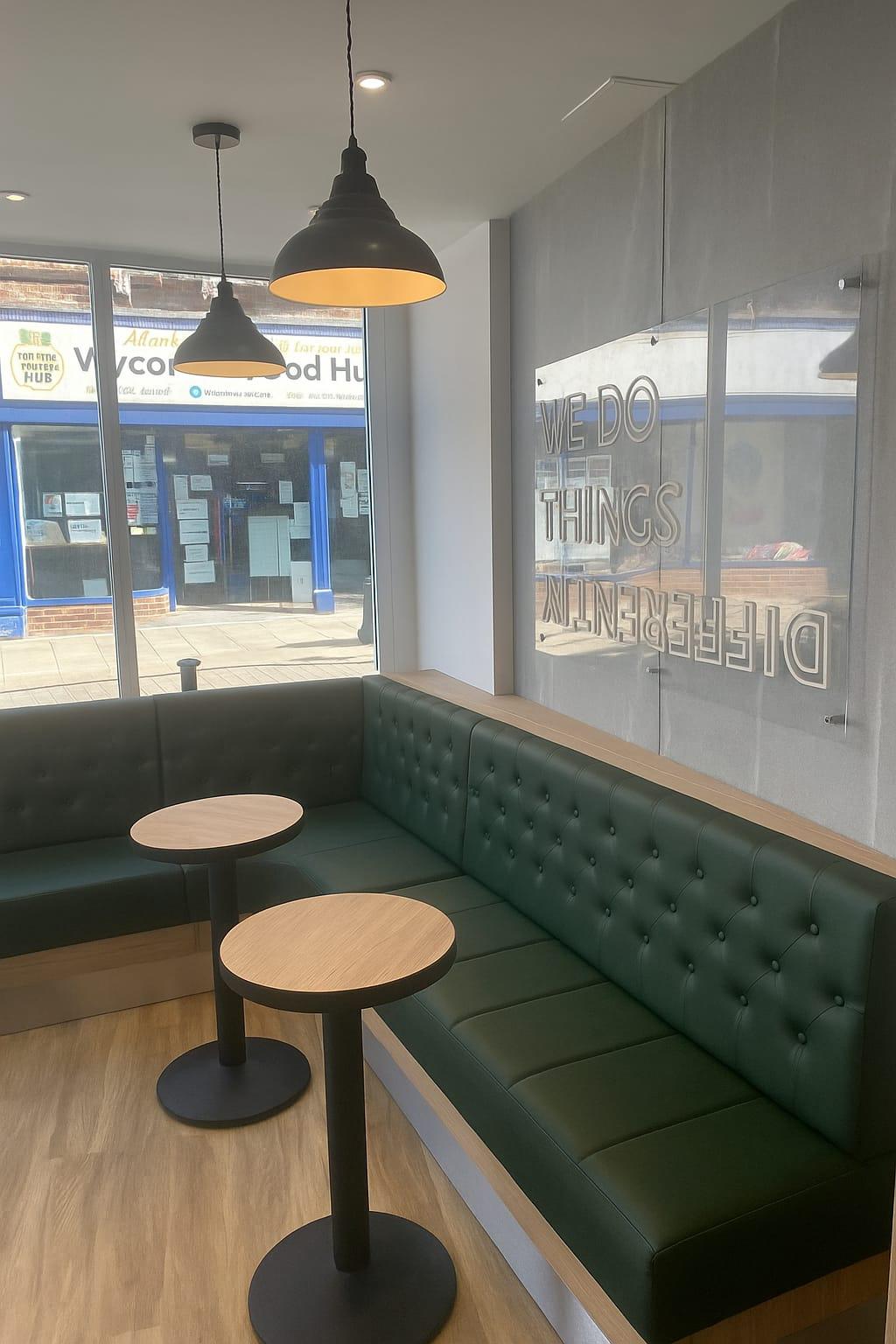 Custom booth seating in deep green faux leather with classic button-tufted backrests — ideal for cafes, restaurants or casual dining spaces.