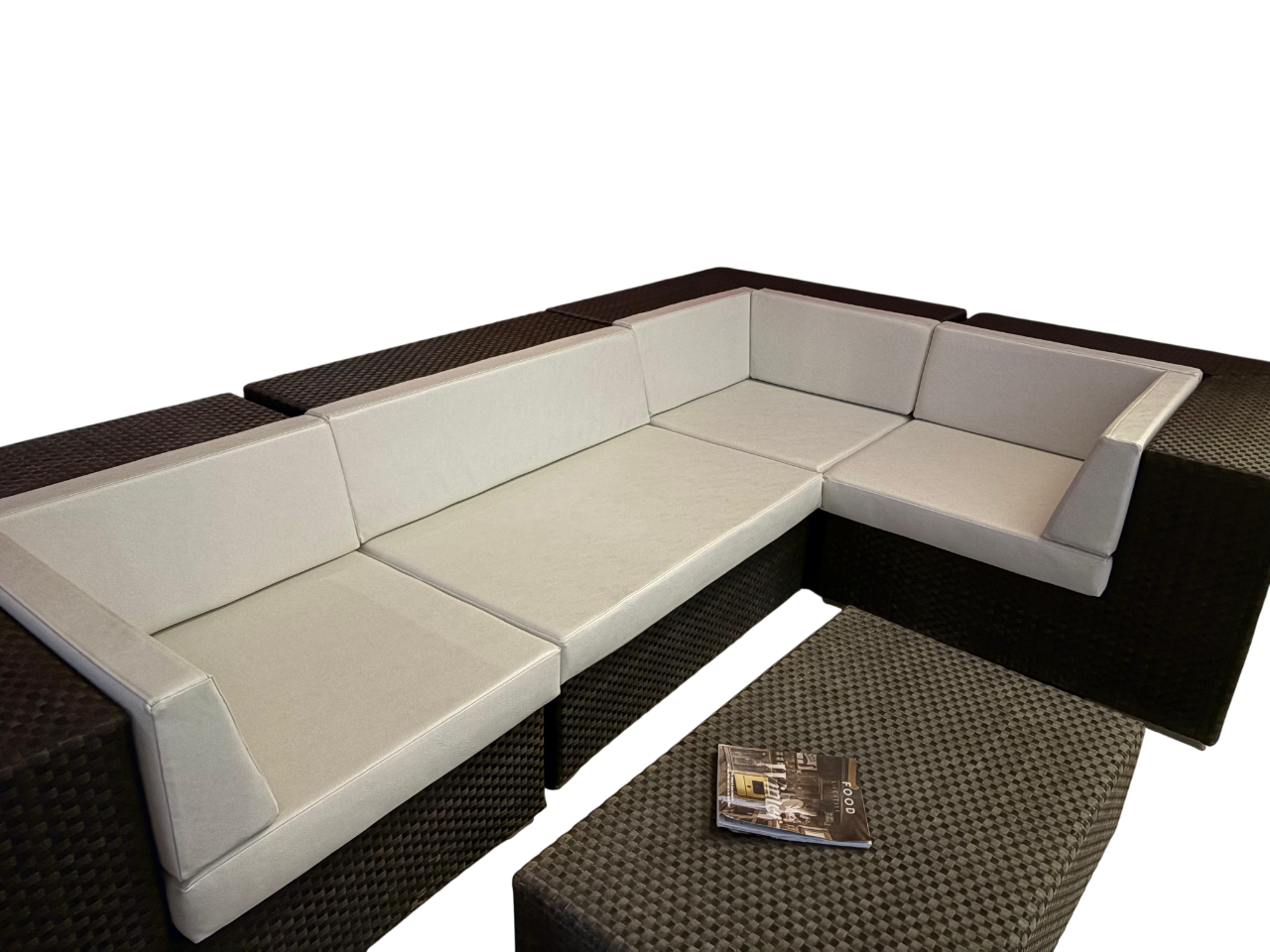 Corner seating with cream cushions on a dark woven rattan frame, made for a spa relaxation area.