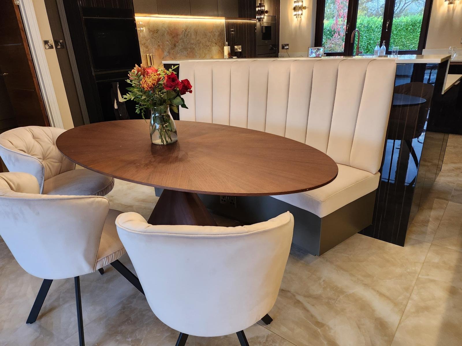 Cream fluted curved banquette seating in a modern home