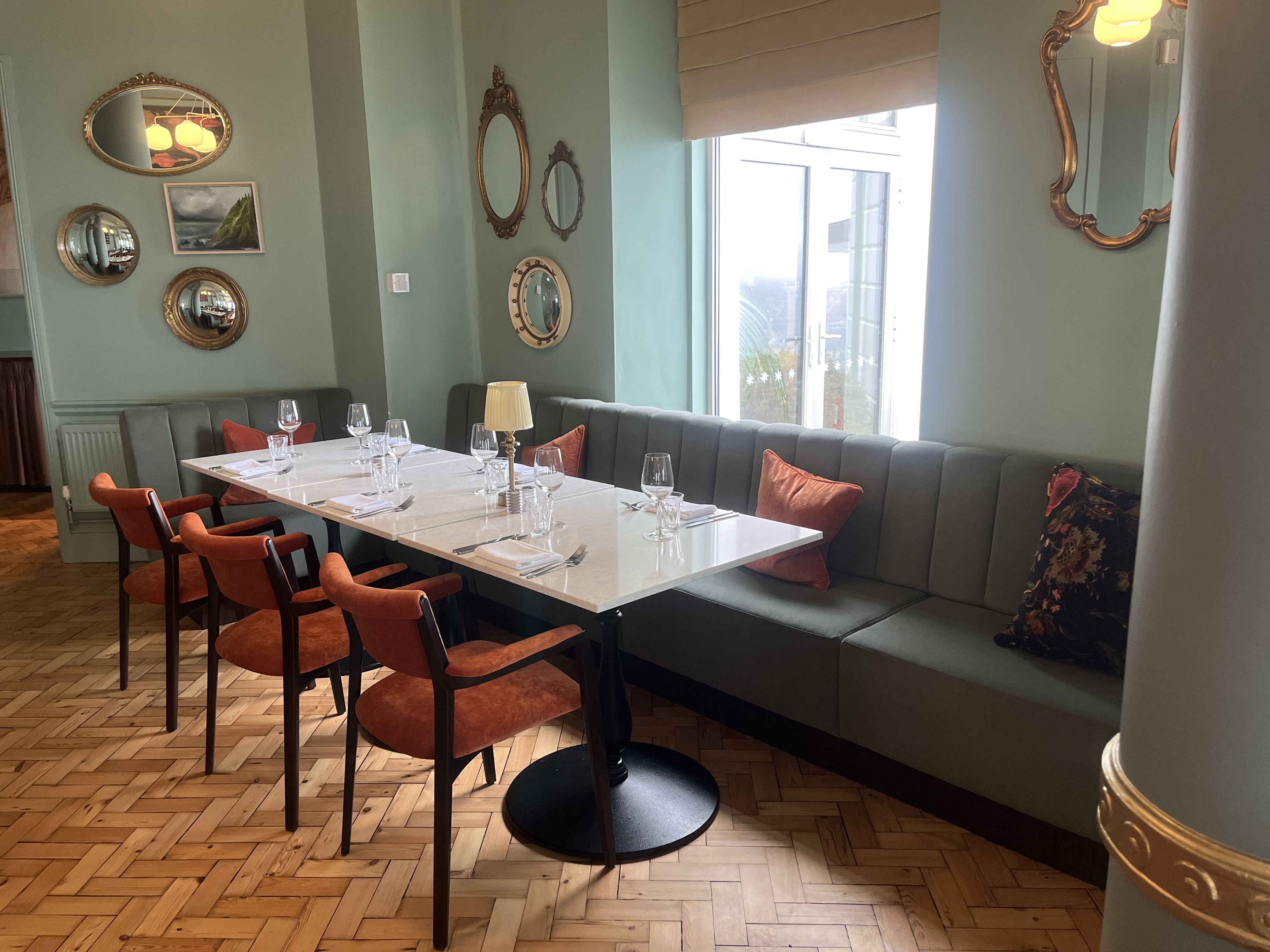 Sage green fluted banquette seating in a restaurant